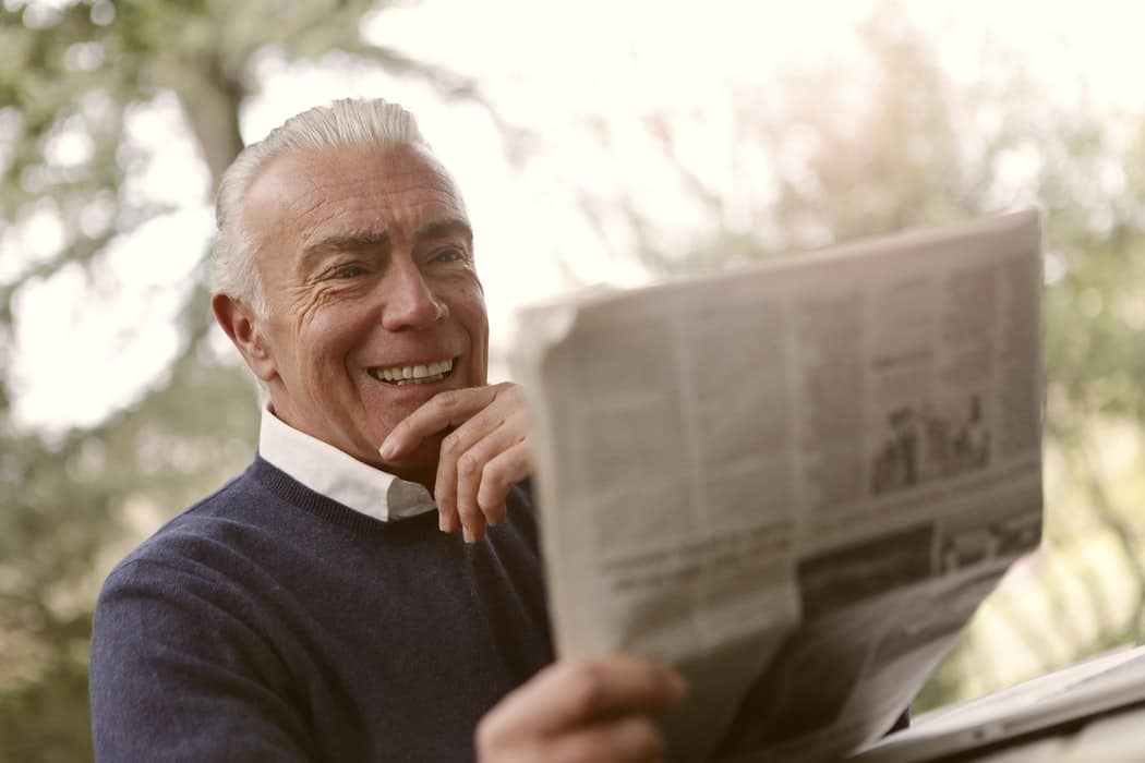 Does Hearing Loss Trigger Alzheimer's? Man reads newspaper