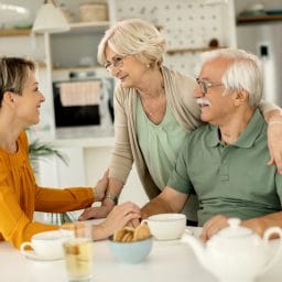 Adult daughter talking with her parents.