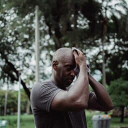 Senior man sweating after going for a walk on a hot day.