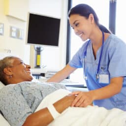 Nurse talking to a senior woman patient in the hospital.