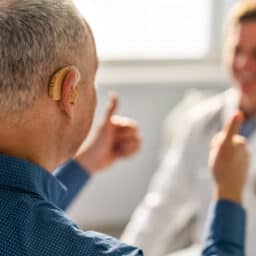Man with hearing loss talks to doctor