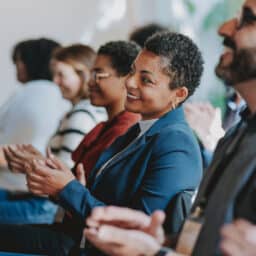 Audience members listen to a speaker