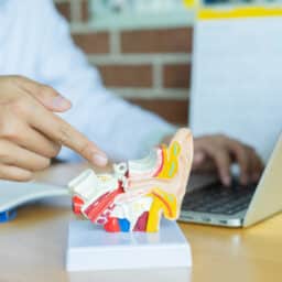 Audiologist pointing at an ear