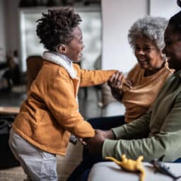 Child plays with family members