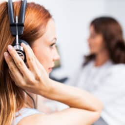 Close-up of a young woman taking a hearing test