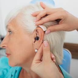 Senior woman getting a new hearing aid