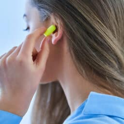 Young woman uses hearing protection