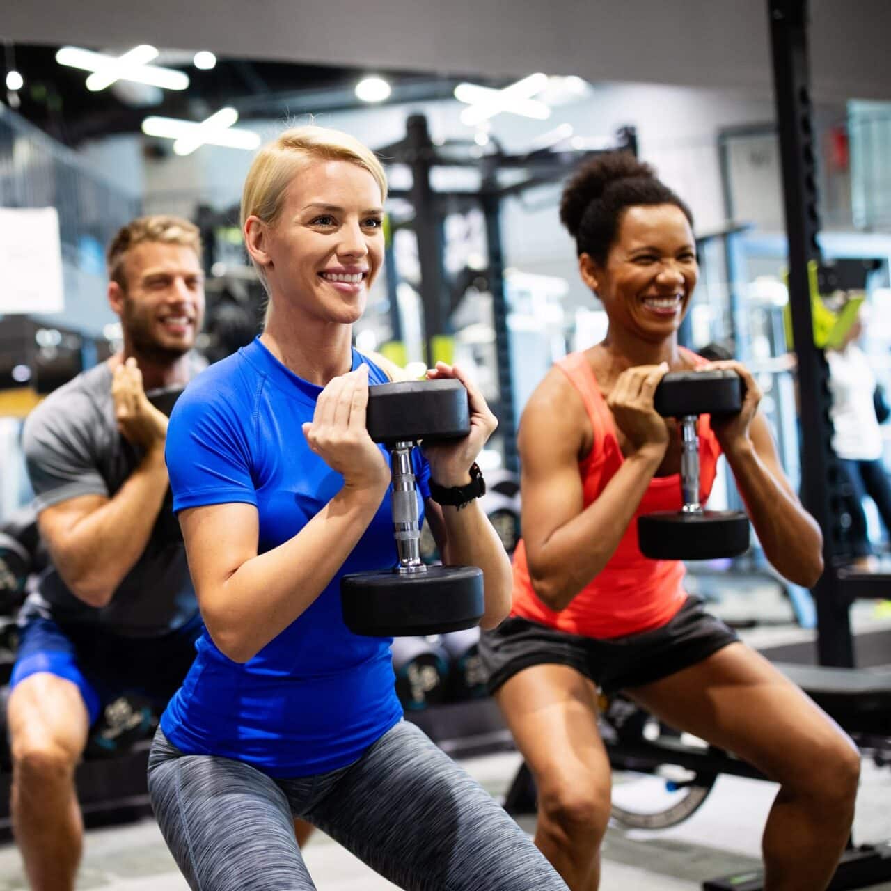 People taking a weightlifting class and having a great time.