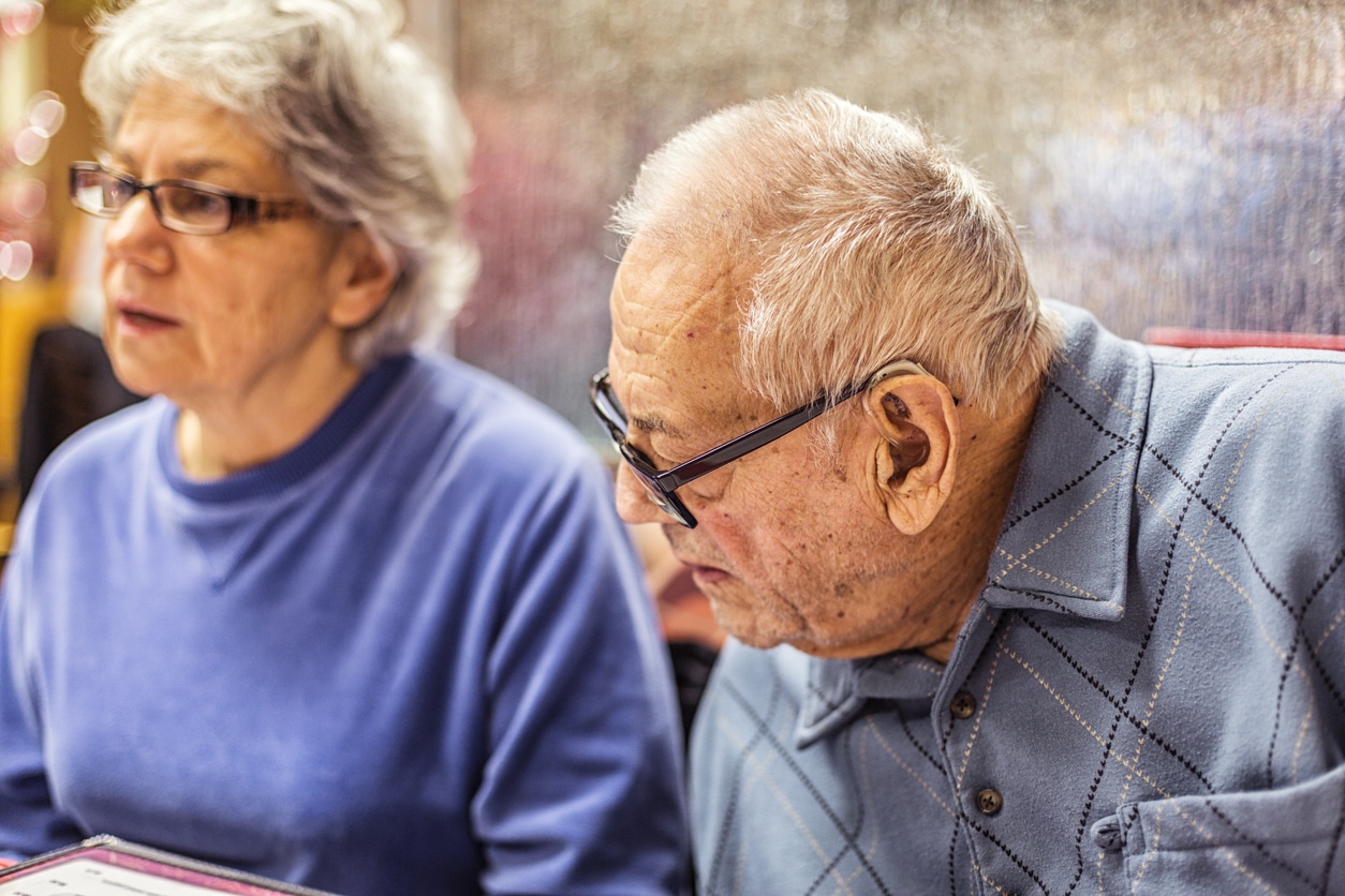 man with hearing loss tilting head to listen
