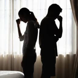 Silhouette of a couple feeling frustrated and remorseful after a disagreement. Communication is the bedrock of any relationship.